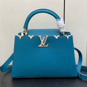 CAPUCINES MM 31 BLUE TAURILLON GOLD HARDWARE