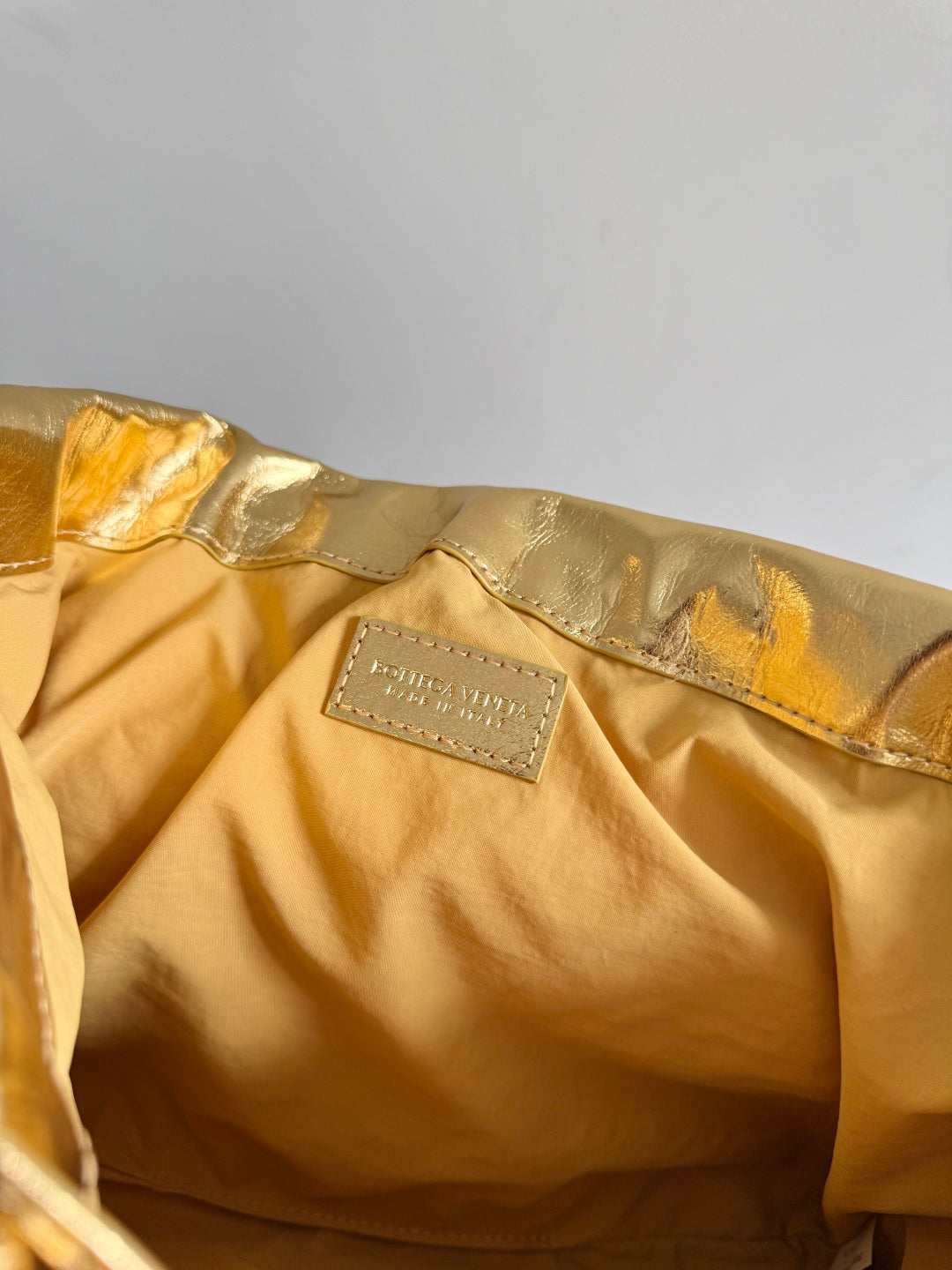 Bottega Veneta 2026 Dust Bag Gold Laminated Leather