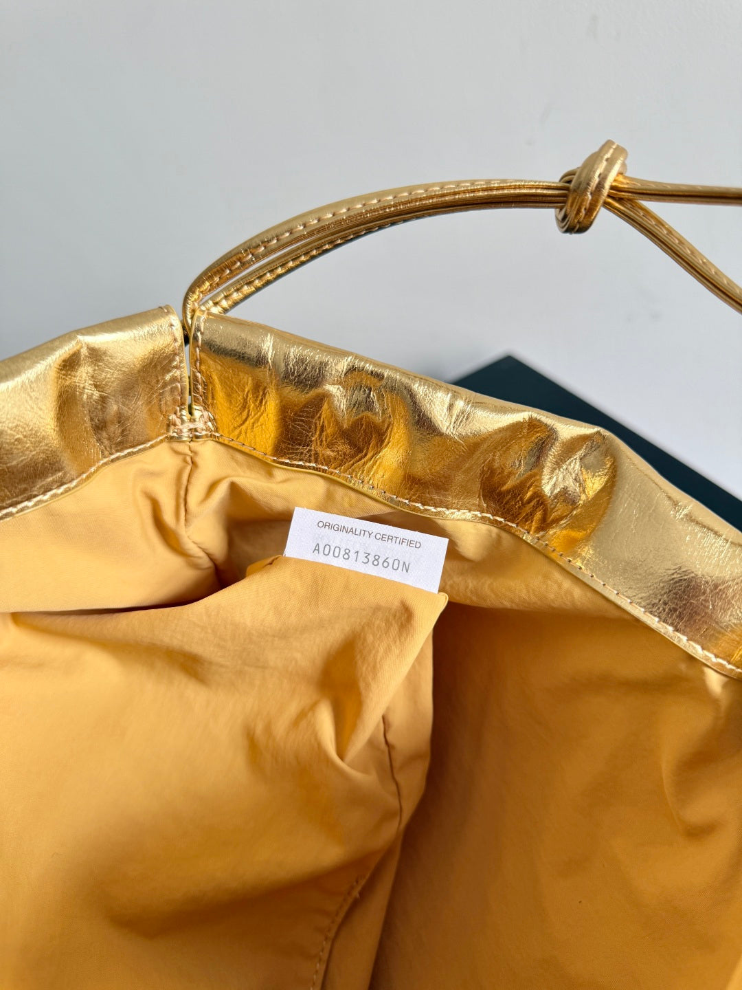 Bottega Veneta 2026 Dust Bag Gold Laminated Leather