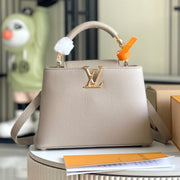 CAPUCINES BB 27 DARK BEIGE TAURILLON GOLD HARDWARE