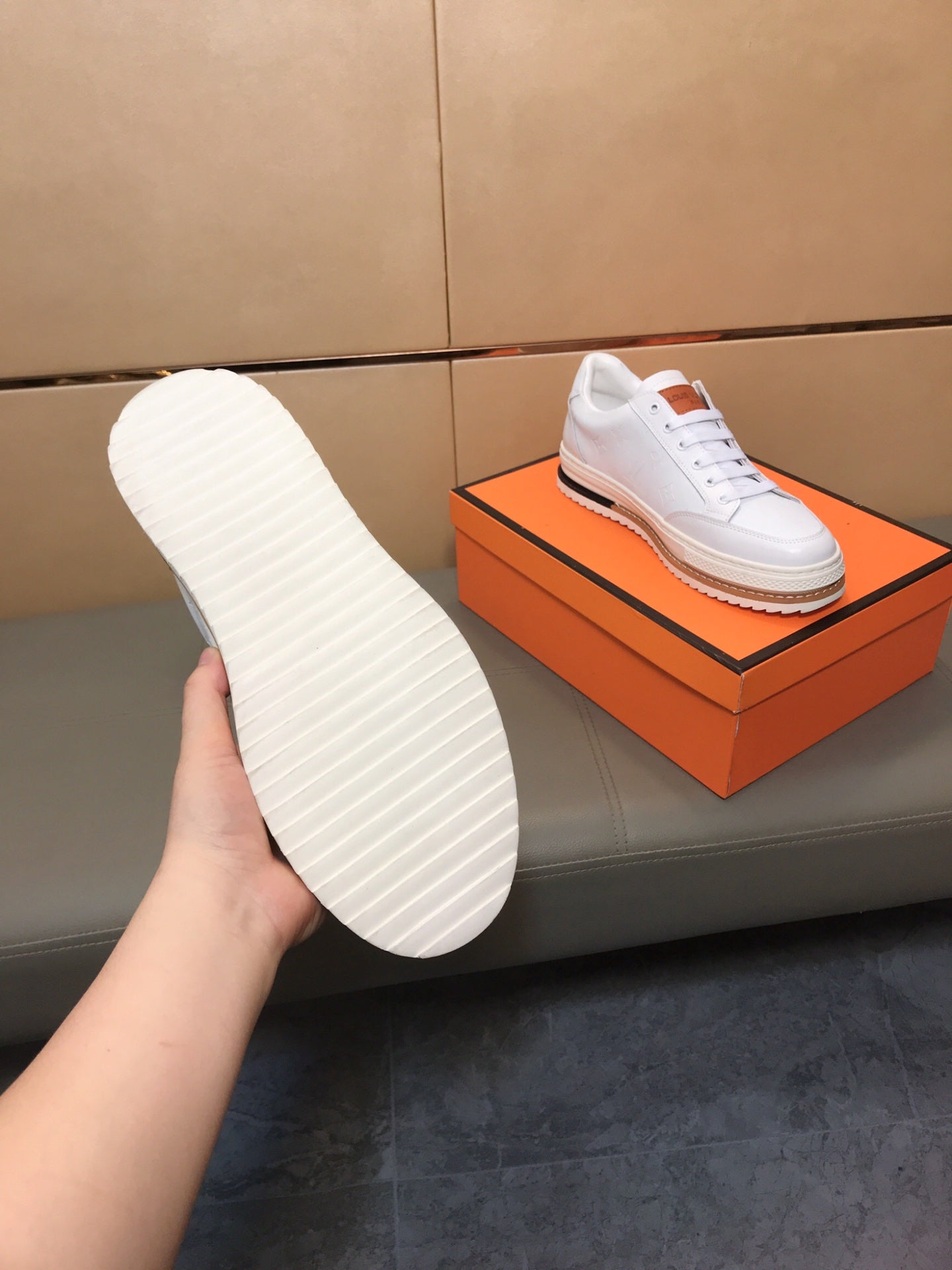 LV TRAINER IN EMBOSSED WHITE SUEDE